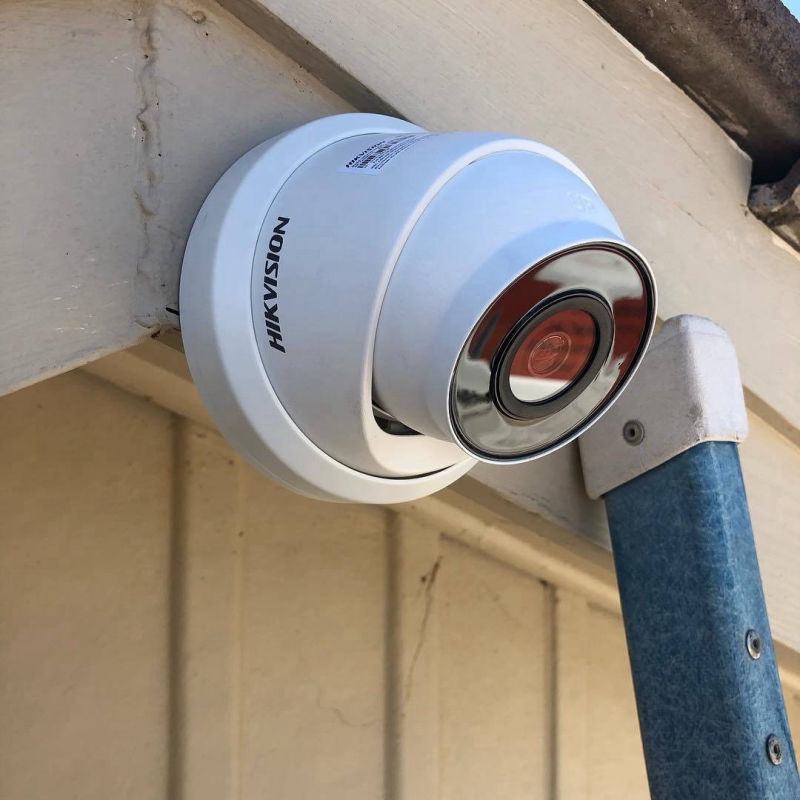 Photo shows a hikvision turre camera mounted on an eve bext to a ladder